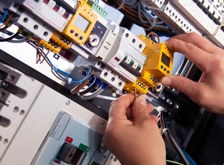 electrician installing digital sensor in an electrical panel